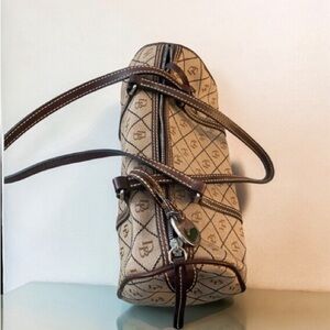 Dooney and Bourke barrel bag. Older design, black and light brown with straps.